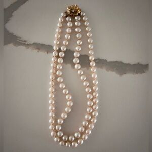 Vintage costume pearl double strand necklace with gold tone flower clasp